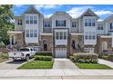 Charming townhome with stone accents, attached garages, and well-manicured landscaping, offering a desirable curb appeal at 5824 Cameo Glass Way, Raleigh, NC 27612