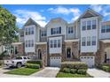 Charming townhome with stone accents, attached garages, and well-manicured landscaping, offering a desirable curb appeal at 5824 Cameo Glass Way, Raleigh, NC 27612