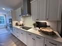 Modern kitchen with white cabinets, stainless steel appliances, and sleek countertops at 5900 Dunzo Dr, Raleigh, NC 27617