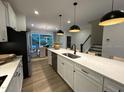 Bright, open kitchen with stainless steel appliances and white cabinetry, seamlessly connected to the dining area at 5904 Dunzo Dr, Raleigh, NC 27617