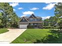 Attractive home featuring a two-car garage, manicured lawn, and traditional design elements at 6332 Mountain Oaks Way, Wake Forest, NC 27587