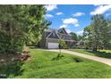 Exterior view of a two-story home with a well-maintained lawn and long driveway at 6332 Mountain Oaks Way, Wake Forest, NC 27587