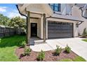 A beautifully landscaped front entrance with a dark stained wood column and a two-car garage at 703 E Markham Ave, Durham, NC 27701