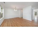 Bright, open dining room with hardwood floors and elegant chandelier lighting at 709 Woodgreen Dr, Durham, NC 27704