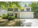 Charming two-story home with white siding, black shutters, and a two-car garage at 709 Woodgreen Dr, Durham, NC 27704