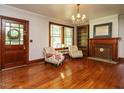 Elegant living room featuring hardwood floors, a fireplace, and a decorative chandelier at 714 Spring Ln, Sanford, NC 27330