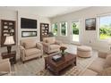 Bright and inviting living room featuring a modern fireplace, stylish furnishings, and scenic outdoor views at 823 Biltmore Dr, Sanford, NC 27332
