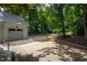 Long driveway leading to detached garage and featuring a basketball hoop for recreation on a large private lot at 8604 Timberwind Dr, Raleigh, NC 27615