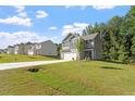 A view of the exterior and front yard on a sunny day at 94 Taverners Ln, Angier, NC 27501