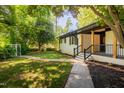 Charming one-story home featuring a walkway to the covered front porch and well-manicured yard at 944 Athens Dr, Raleigh, NC 27606