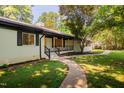 Charming one-story home featuring a walkway to the covered front porch and well-manicured yard at 944 Athens Dr, Raleigh, NC 27606