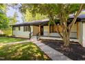 Charming single-story home with white brick, black trim, and inviting front porch at 944 Athens Dr, Raleigh, NC 27606