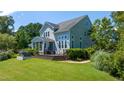 Lush lawn, expansive deck, hot tub, and screened porch offer relaxation and comfort at 9701 Corktree Ct, Wake Forest, NC 27587