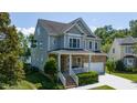 Charming two-story home with stone accents, a covered porch, and attached garage at 9701 Corktree Ct, Wake Forest, NC 27587