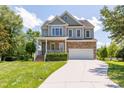 Charming two-story home featuring a stone facade and well-kept landscaping at 9701 Corktree Ct, Wake Forest, NC 27587