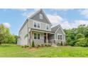 Beautiful home features a manicured lawn and an attractive exterior color scheme, enhancing its curb appeal at 0 Bluestone Ct # 22 R, Chapel Hill, NC 27514