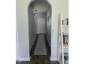 Inviting hallway features an archway and dark wood-look flooring, creating a warm and welcoming entrance at 109 E Webber Lane Ln, Clayton, NC 27527