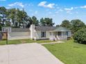 Well-maintained home featuring a basketball court, lush lawn, and inviting front porch at 111 Marshay Meadow Rd, Youngsville, NC 27596