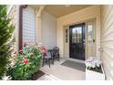 Cozy front porch with seating, flowers, and a welcoming entryway at 1137 Amber Shadow Dr, Durham, NC 27703