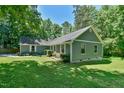 A charming single story home with a green yard and colorful flowers in the window boxes at 1205 Hillsborough Rd, Chapel Hill, NC 27516