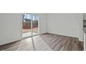 Bright living area with stylish wood flooring and sliding glass doors to the outdoor patio at 1240 Pond Overlook, Nashville, NC 27856