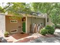 Charming exterior with a green front door, solar panels, unique art, and mature landscaping at 1320 Shepherd St, Durham, NC 27707