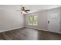 Bright living room with hardwood floors, a ceiling fan and a window providing natural light at 136 Dixie Ln, Youngsville, NC 27596