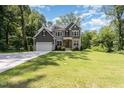 Stunning two-story home with a well-manicured lawn and a long driveway leading to the garage at 1417 Westmoreland Dr, Raleigh, NC 27612