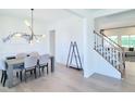 Bright and airy dining room open to a staircase with natural lighting and hardwood floors at 1425 Sierra Glen Cir, Apex, NC 27502