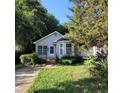 Inviting single-story home with lush greenery, well-maintained lawn, and an appealing facade at 1512 E Lane St, Raleigh, NC 27610