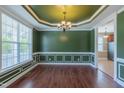 Bright dining room featuring natural light, decorative moldings, hardwood floors, and an elegant chandelier at 168 Melody Ln, Cameron, NC 28326