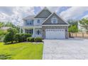 Charming two-story home with stone accents and a spacious driveway showcasing curb appeal at 168 Melody Ln, Cameron, NC 28326