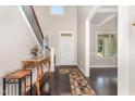Bright foyer with hardwood floors, staircase, and decorative console table at 1726 Rapids Ct, Franklinton, NC 27525
