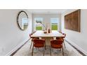 Bright dining room featuring a large window with natural light, seating for six and modern decor at 182 E Fountainhead Ln, Garner, NC 27529