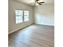Bright living room featuring sleek floors, recessed lighting, and large windows at 189 Seville Way, Clayton, NC 27520