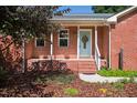 Inviting front porch with a decorative wreath on the light blue front door at 1975 Oakridge Duncan Rd, Fuquay Varina, NC 27526