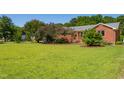 Spacious front yard with mature trees surrounding this well-maintained brick home at 1975 Oakridge Duncan Rd, Fuquay Varina, NC 27526