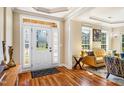 Inviting foyer with hardwood floors, decorative door, and view into a stylish living room at 2129 Glade Valley Ln, Morrisville, NC 27560