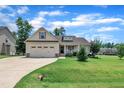 Charming one-story home featuring a well-manicured lawn and two-car attached garage at 22 Evie Dr, Smithfield, NC 27577