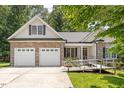 Charming home with stone accents, a two-car garage, and accessible ramp at 23 Northern Way Ct, Durham, NC 27712