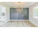 Bright dining room featuring modern wainscoting and updated lighting at 2300 Radius Cir, Sanford, NC 27330