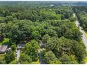 Beautiful aerial view of lush wooded landscape and surrounding neighborhood provides a sense of community and seclusion at 235 Mccauley St # D, Chapel Hill, NC 27516
