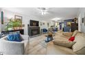 Cozy living room with a fireplace, neutral decor, and an open layout to the kitchen at 2603 Stafford Ave # Apt C, Raleigh, NC 27607