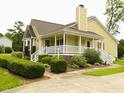 Charming home featuring a welcoming front porch, well-maintained landscaping, and a brick-paved walkway at 2817 Buckboard Ln, Raleigh, NC 27603