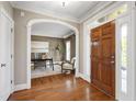 Elegant foyer with gleaming hardwood floors and an open view to a cozy office space at 307 Beacon Falls Ct, Cary, NC 27519