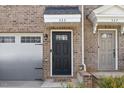Close up of the front door, garage door and brick facade at 333 Amber Acorn Ave, Raleigh, NC 27603