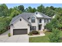 Beautiful two-story brick home featuring an attached two-car garage and a well-maintained front lawn at 4219 Peachway Dr, Durham, NC 27705