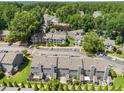 Aerial view showcasing well-maintained townhomes, lush trees, and ample parking spaces at 4649 Pine Trace Dr, Raleigh, NC 27613
