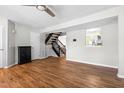 Inviting living room with hardwood floors, staircase, and an open view to the kitchen at 4649 Pine Trace Dr, Raleigh, NC 27613