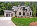 Beautiful home featuring an attached garage, manicured lawn, and brick accents at 503 Damascus Church Rd, Chapel Hill, NC 27516